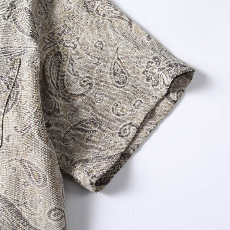 Short sleeve detail of men’s paisley Cuban collar shirt showing stitching and fabric finish.
