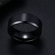Black 8mm men's ring minimalist band textue detailclose up.