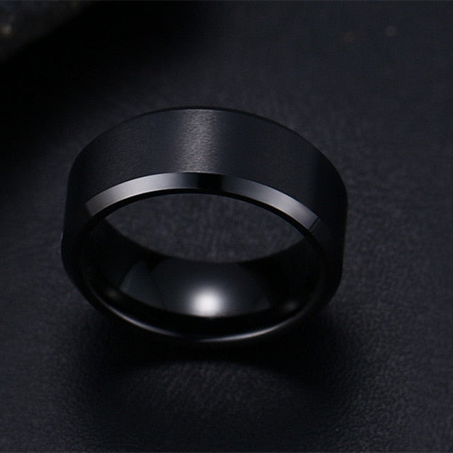 Black 8mm men's ring minimalist band textue detailclose up.