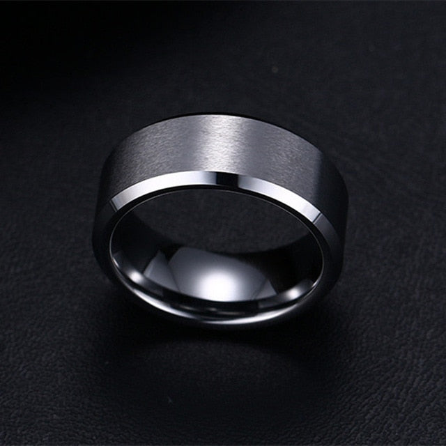Siver 8mm men's ring minimalist polished band close up.