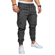 slim fir cargo joggers for men in dark gray, featuring drawstring waist and cuffed ankles, paired with white sneakers.