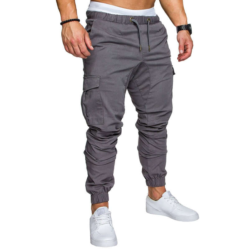 Slim fir cargo joggers for men in gray, featuring a stylish design with elastic cuffs and pockets, model wearing white sneakers.
