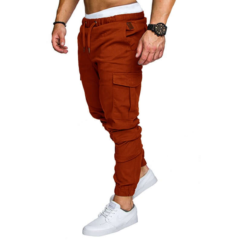 Slim fir cargo joggers for men in rust color, featuring side pockets and tapered fit, ideal for casual wear.