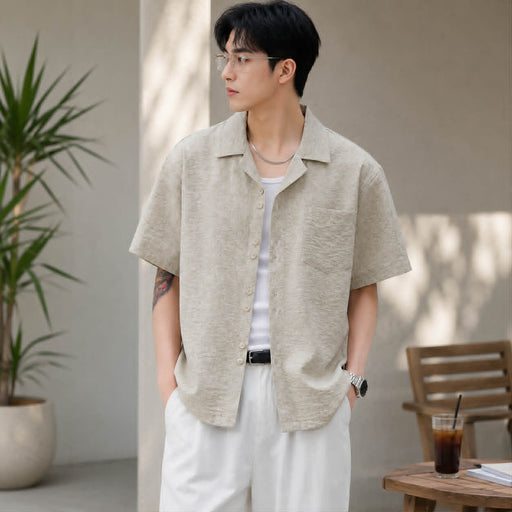 Man wearing apricot textured Cuban collar short sleeve shirt in a casual summer lifestyle setting.
