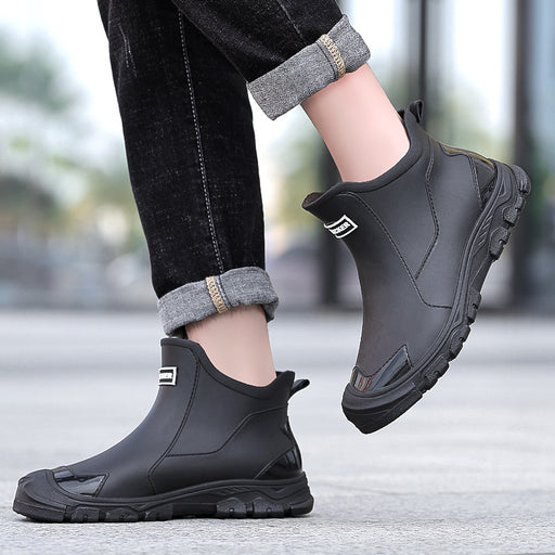 Men wearing black short rain boots with slip-on design and rugged anti-slip outsole for rainy days
