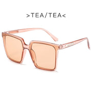 Oversized square sunglasses for women with champagne frame and black gray UV protection lenses
