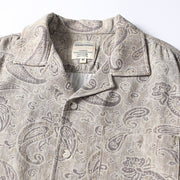 Close-up detail of men’s paisley print Cuban collar shirt
