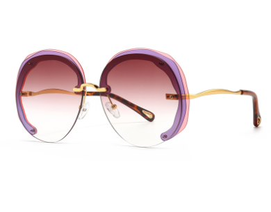 Pink tan rimless oversized cut lens sunglasses featuring gradient lenses and lightweight gold metal frame.
