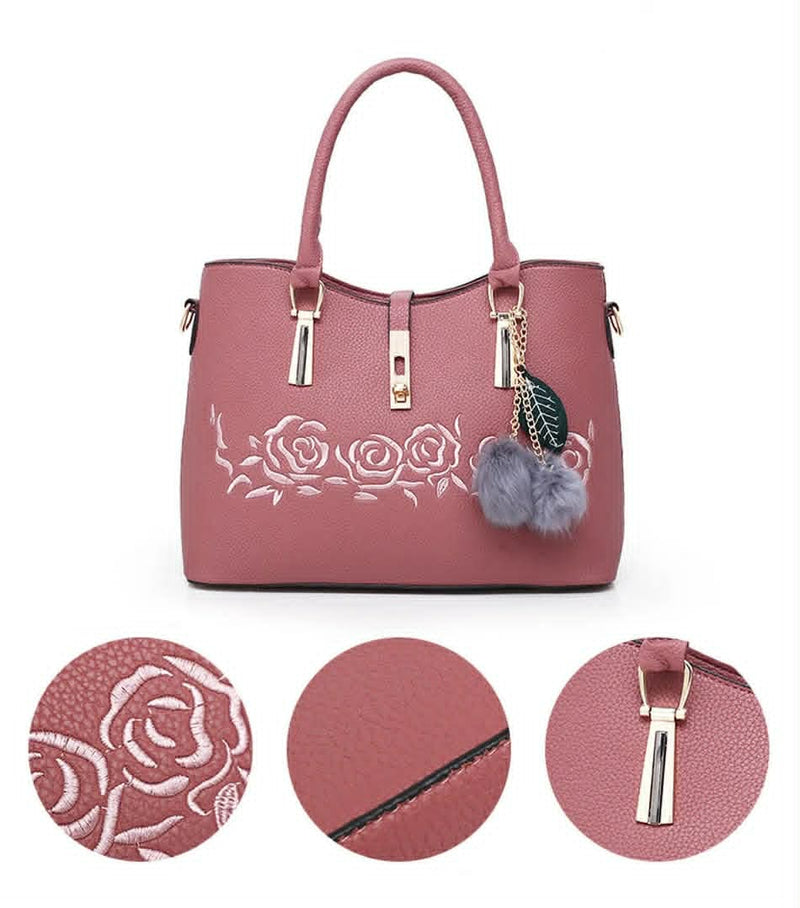  Pink handbag featuring embossed rose floral design, textured leather, and gold-tone hardware