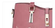  Close-up of premium gold-tone hardware and lock detail on pink embossed rose handbag