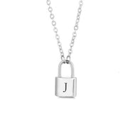 Silver initial lock necklace with letter J pendant on a minimal clean background
