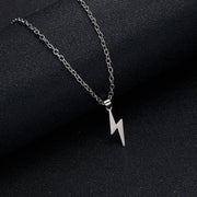 Detailed view of silver lightning bolt pendant necklace with stainless steel chain on dark background