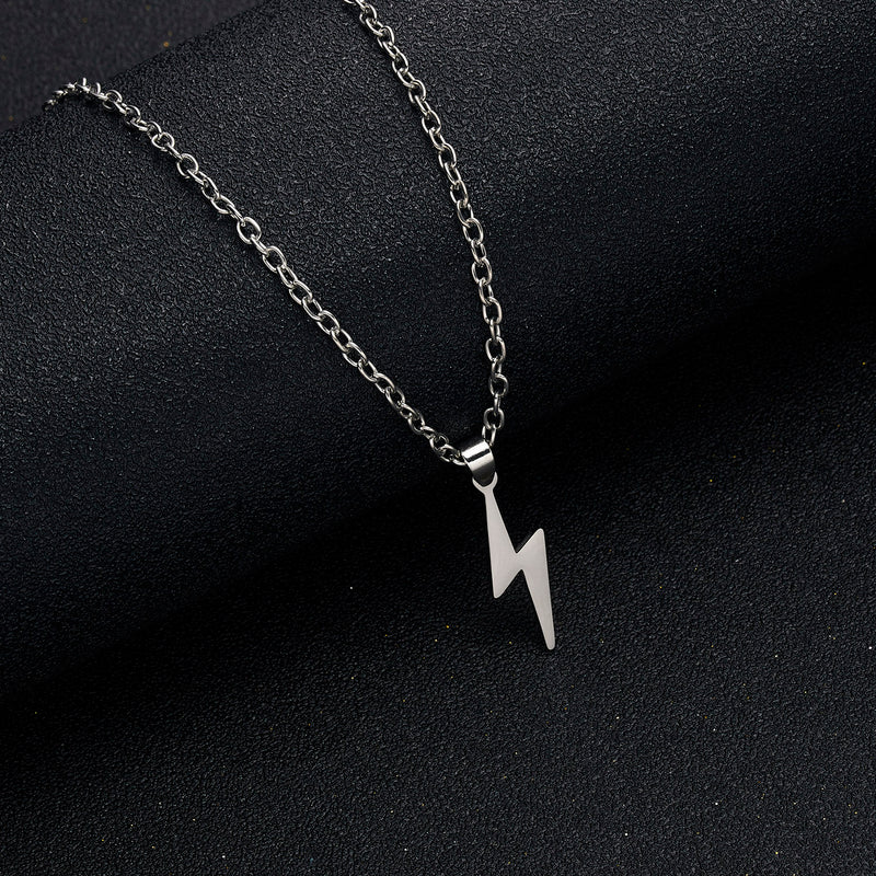 Detailed view of silver lightning bolt pendant necklace with stainless steel chain on dark background