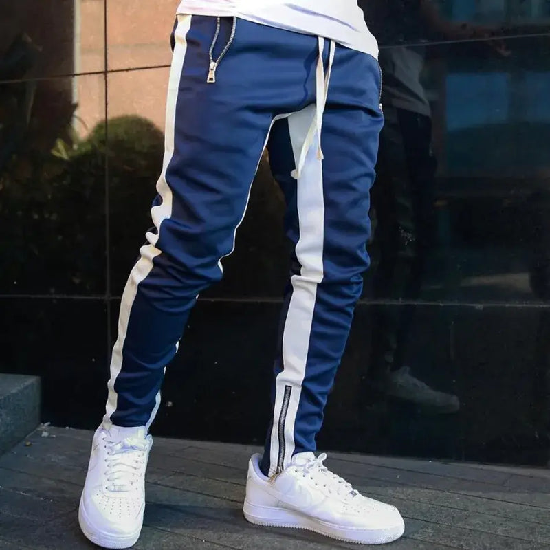 skinny joggers for men in navy with white stripes, styled with white sneakers.