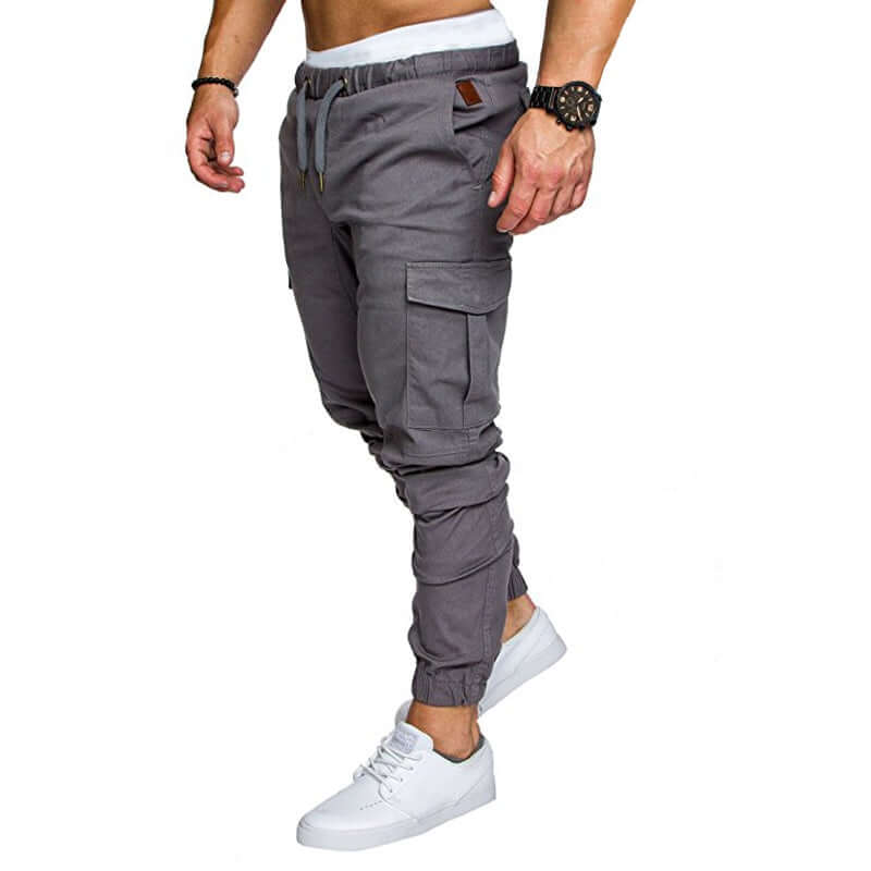 Slim fir cargo joggers for men in gray with elastic cuffs and pockets, styled with a casual white t-shirt and white sneakers.