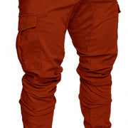 slim fir cargo joggers for men in burnt orange color with practical cargo pockets and tapered design