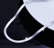Close up of flat snake chain neclace smooth flexible stainless steel with shine detail