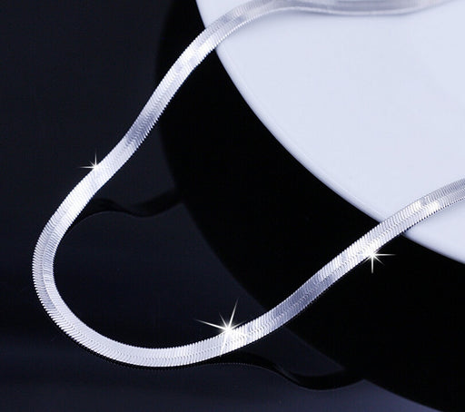 Close up of flat snake chain neclace smooth flexible stainless steel with shine detail
