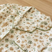Close-up of floral cotton gauze pajama collar and button details
