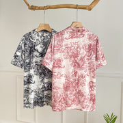 Back view of elegant watercolor satin pajama sets for women in pink and black featuring a lightweight short-sleeve design.

