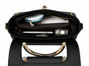 Interior compartment of black structured crossbody handbag with multiple storage pockets.
