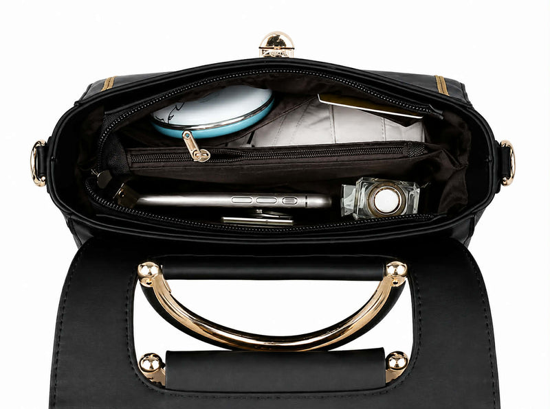 Interior compartment of black structured crossbody handbag with multiple storage pockets.

