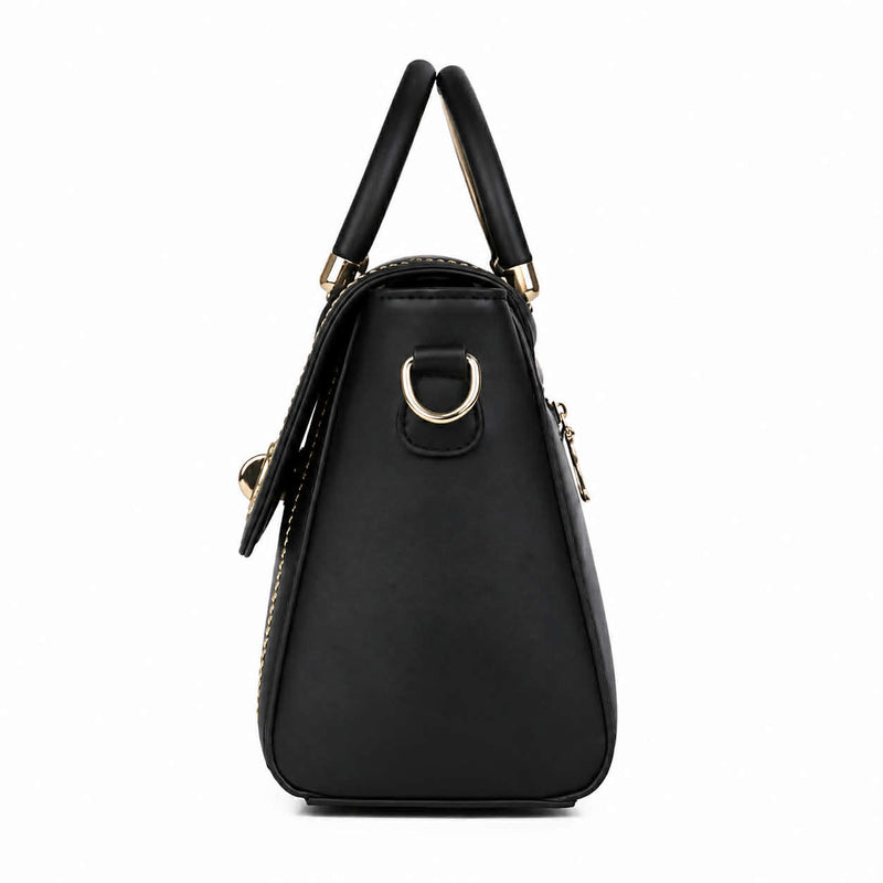 Side profile of black structured crossbody handbag showing its compact shape and metal hardware.
