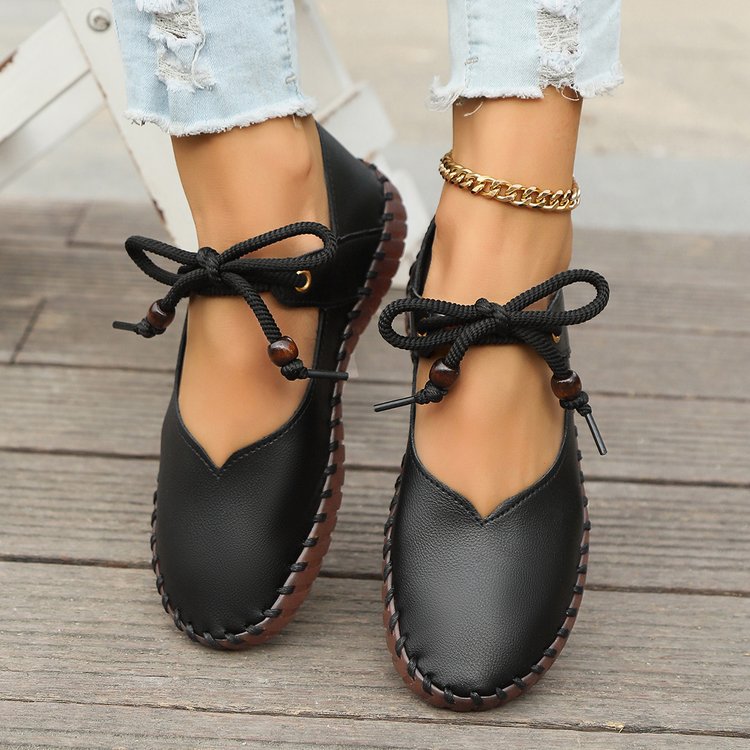 Front view of women’s black casual lace-up sneakers with a lightweight flat sole and classic everyday design.
