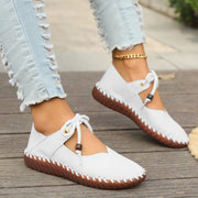 Women’s white casual lace-up sneakers with a lightweight design and comfortable flat sole for everyday walking and casual wear.
