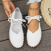 Top view of women’s white casual lace-up sneakers with breathable construction and cushioned comfort for everyday use.
