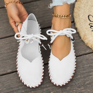 Top view of women’s white casual lace-up sneakers with breathable construction and cushioned comfort for everyday use.
