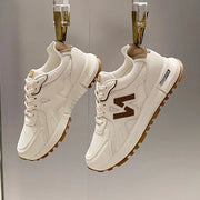 Women’s chocolate lightweight mesh running sneakers with breathable upper and cushioned sole.
