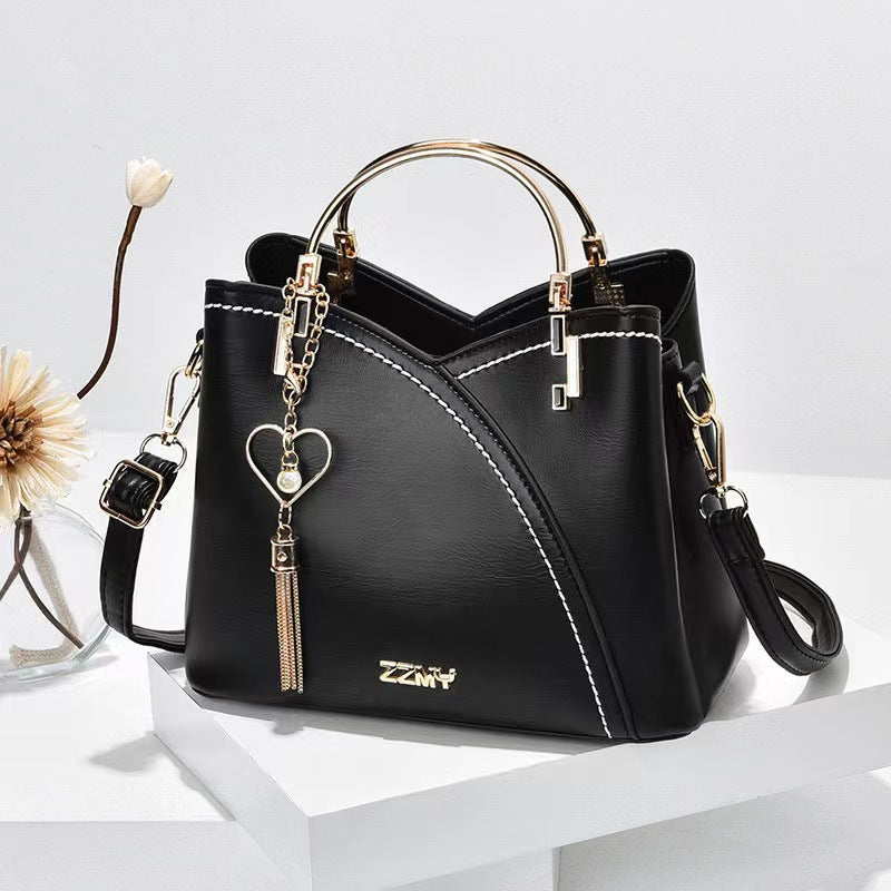 Black women's color block handbag with elegant design and crossbody shoulder strap
