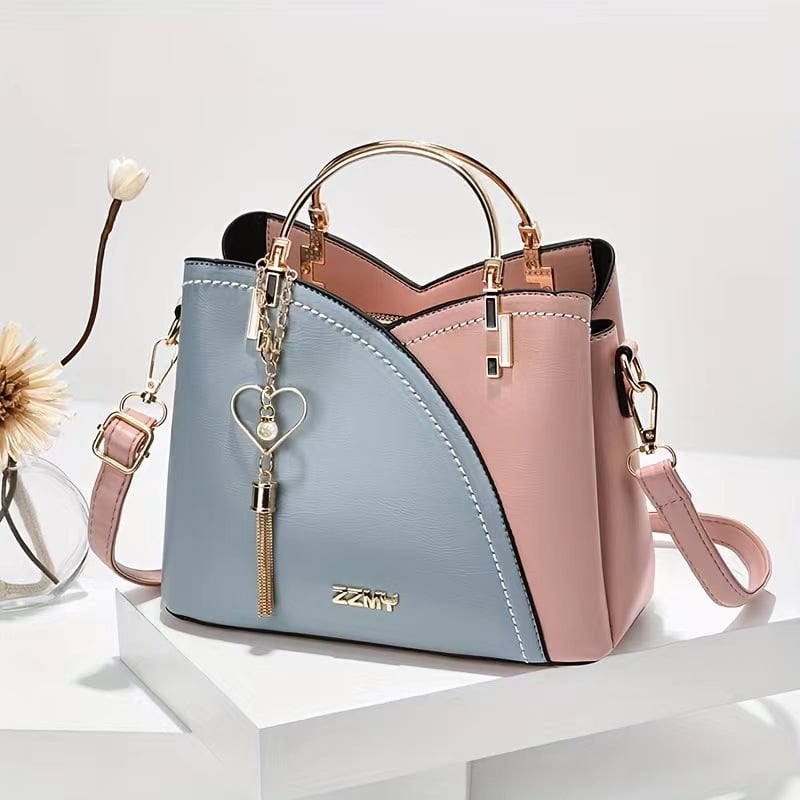 Blue and pink women's color block shoulder bag with spacious interior and adjustable strap

