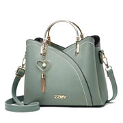Green women's color block handbag with adjustable shoulder strap and large storage capacity
