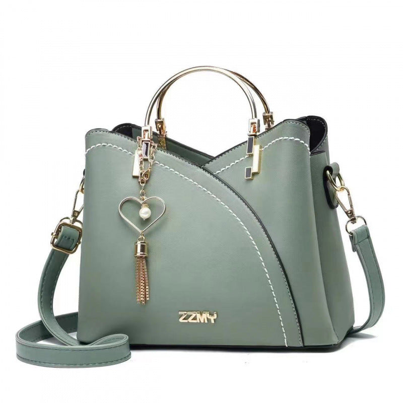 Green women's color block handbag with adjustable shoulder strap and large storage capacity
