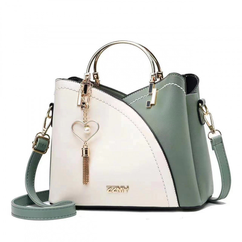 White and green women's color block shoulder bag with spacious interior and stylish design
