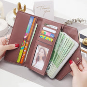 Women's designer clutch wallet with multiple card slots, cash compartment, and coin pocket
