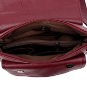 Interior compartments of women's genuine leather crossbody bag with multiple storage pockets
