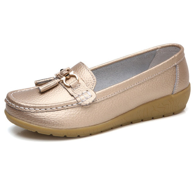 Women’s gold genuine leather slip-on loafers with stylish metallic finish.
