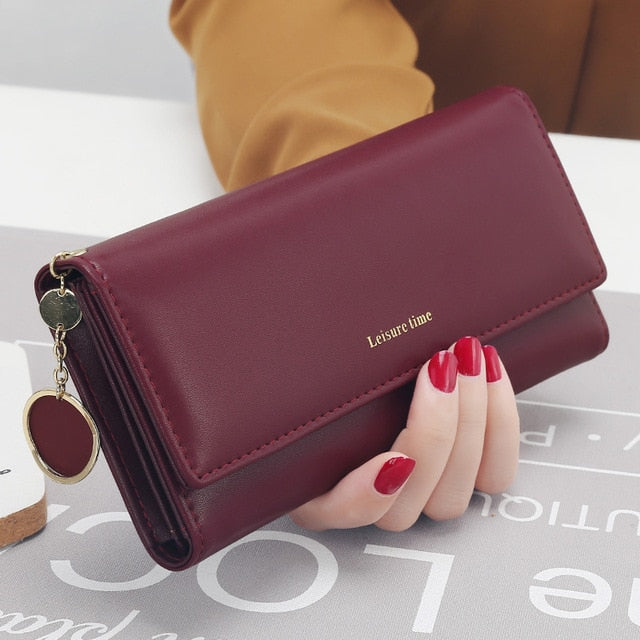 Women's long PU leather wallet in burgundy with elegant fold-over design and zipper compartment
