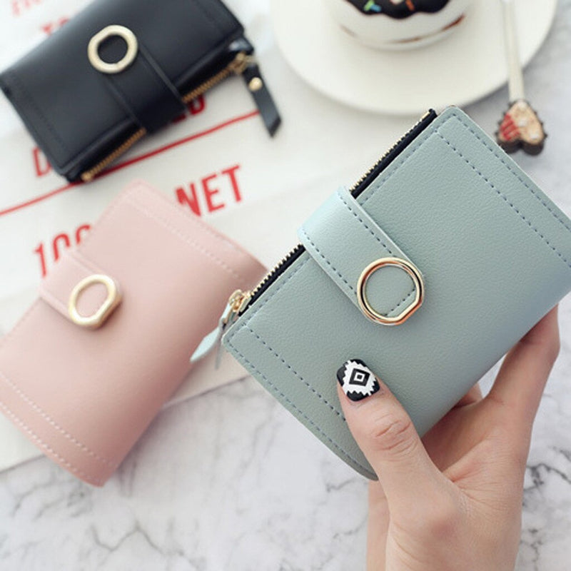 Woman holding a stylish mini PU leather coin purse wallet for everyday use.
