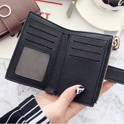 Women's compact wallet featuring card slots, cash compartment, and ID window.
