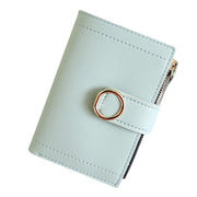 Light green women's mini wallet made from PU leather with secure snap closure.
