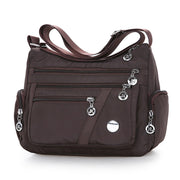 Women’s brown nylon crossbody messenger bag with adjustable shoulder strap
