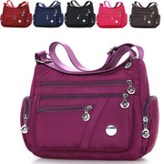 Women’s purple nylon crossbody messenger bag with multiple zippered pockets
