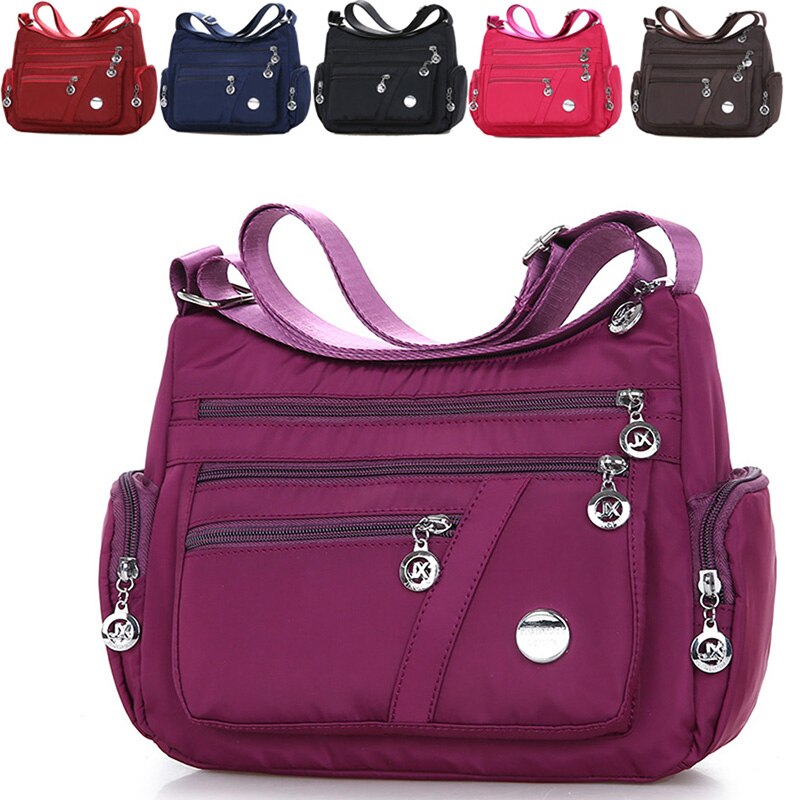 Women’s purple nylon crossbody messenger bag with multiple zippered pockets
