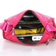 Women’s nylon crossbody messenger bag interior showing large storage capacity and multiple essentials
