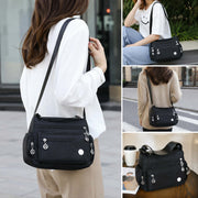 Women’s nylon crossbody messenger bag lifestyle views showing front, back and shoulder carry
