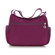 Back view of women’s purple nylon crossbody messenger bag with rear zip pocket
